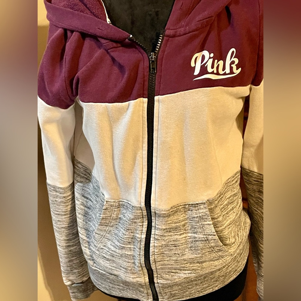 Pink zip up with pockets.